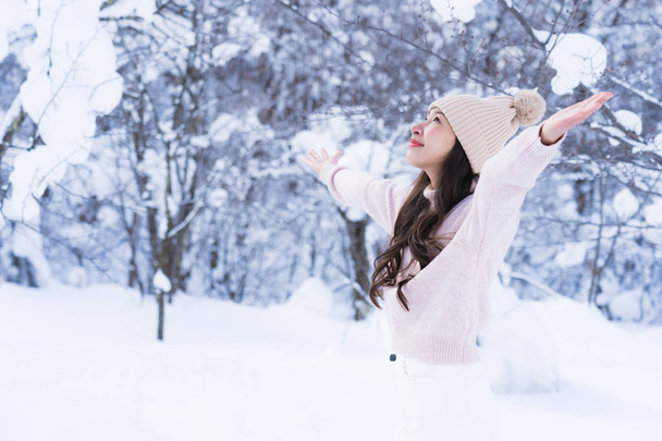 Portrait Young Beautiful asian woman smile happy travel and enjoy with snow winter season in Hokkaido Sapporo Japan - 写真・画像
