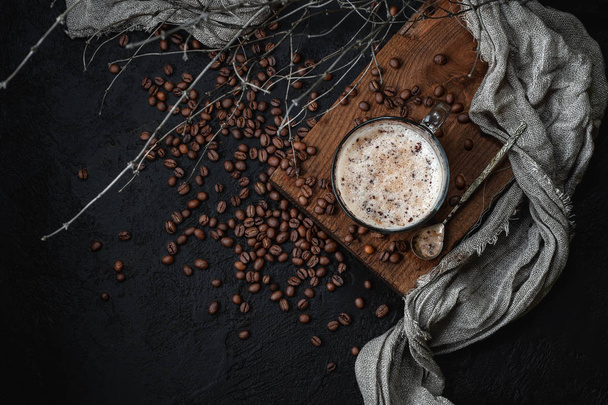 Coffee with milk foam on a dark background. Low key photography - Foto, Imagen