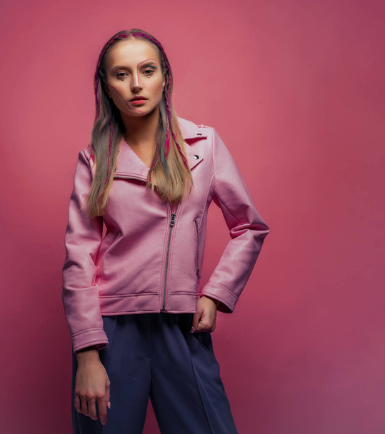 young model with creative makeup wearing pink leather jacket in studio - Fotografie, Obrázek