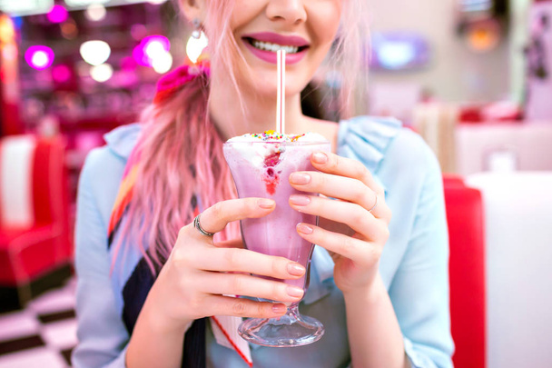  fashion lifestyle portrait of stunning pretty woman drinking milkshake in cafe  - Fotó, kép