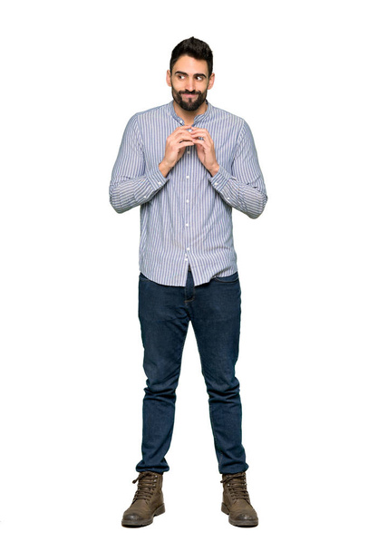 Celovečerní snímek elegantní muže s košilí pikle něco na izolované bílém pozadí - Fotografie, Obrázek