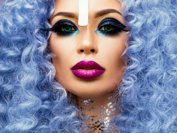 portrait of woman with creative makeup and blue hair - Fotó, kép