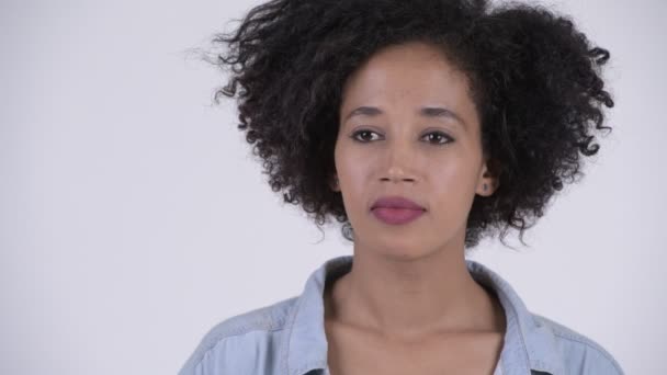 Studio shot of young beautiful African woman with Afro hair against white background - Filmati, video