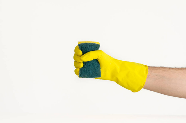 Male hand in yellow latex glove and scrubbing sponge - Photo, Image