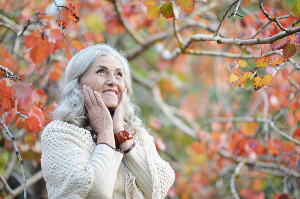 Happy senior woman in park - Photo, Image