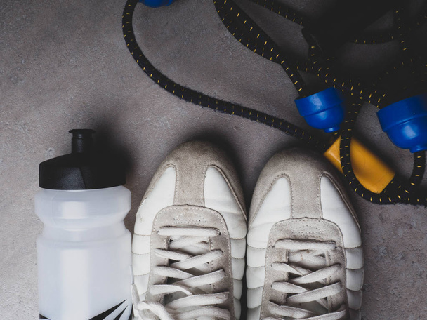 Sportgeräte auf grauem Hintergrund. Ansicht von oben. Motivation, gesunder Lebensstil - Foto, Bild
