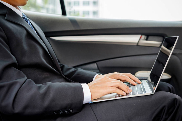 Successful businessman sitting in the back seat of a car - Foto, Imagen