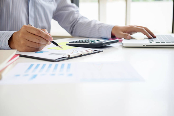 Business adviser analyzing financial figures denoting the progress Internal Revenue Service checking document. Audit concept - Zdjęcie, obraz