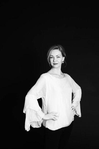 Close up studio portrait of beautiful woman in a white dress against black background - Fotoğraf, Görsel