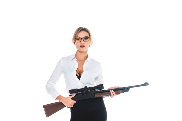 teacher in blous with open neckline, glasses and skirt holding rifle isolated on white - Foto, Imagem