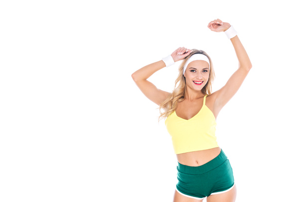 attractive blonde fitness trainer in green and yellow sportswear isolated on white - Фото, зображення