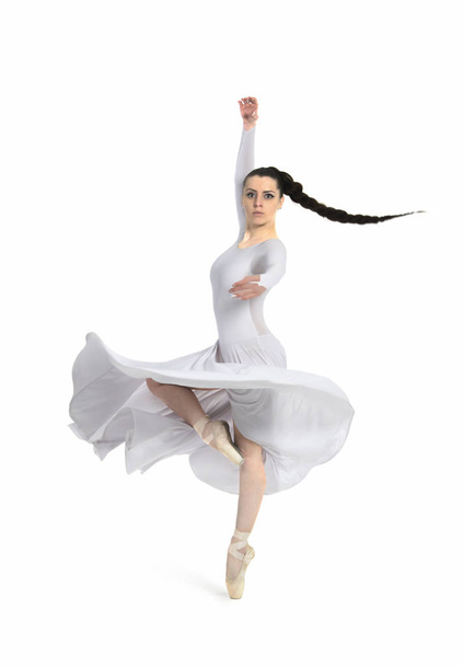 A girl in a white dress, with long hair, dancing ballet. Studio shot on white background, isolated image. - Foto, afbeelding