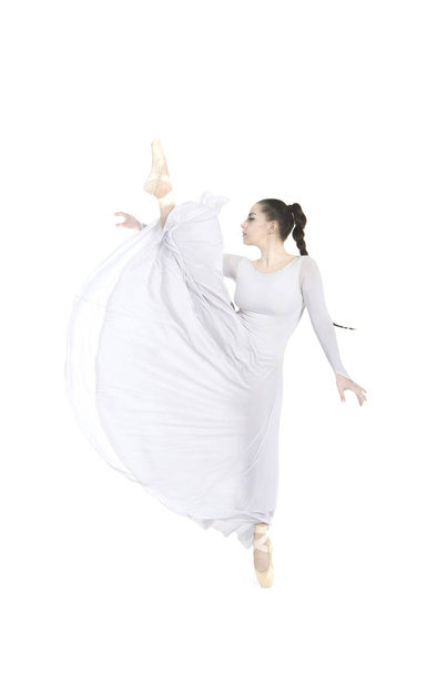 A girl in a white dress, with long hair, dancing ballet. Studio shot on white background, isolated image. - Photo, Image
