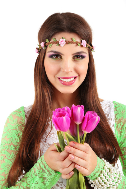 Young beautiful girl with decorative wreath on her head holding bouquet of flowers, isolated on white - Foto, immagini
