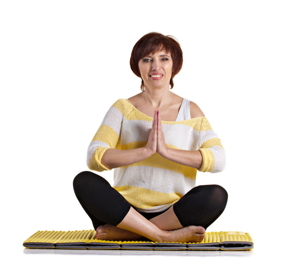 senior woman sitting in yoga pose - Фото, изображение