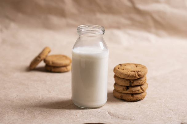 oatmeal cookies on paper background. Flowers and peanut milk.  - Фото, зображення