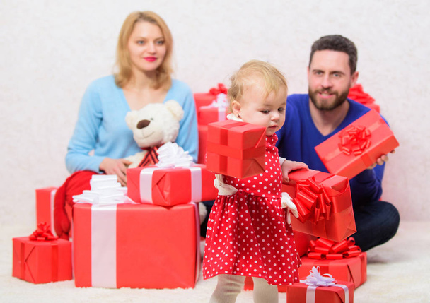 Loving everything about her. Valentines day. Red boxes. Love and trust in family. Bearded man and woman with little girl. father, mother and doughter child. Boxing day. Happy family with present box - Fotó, kép