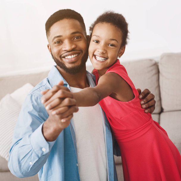 Father and cute daughter dancing at home, crop - Foto, immagini