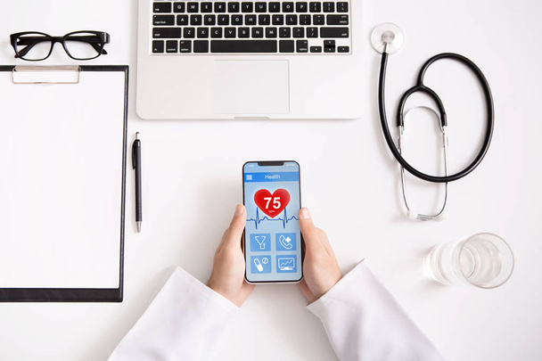Arzt überprüft per Smartphone-App Gesundheitsdaten - Foto, Bild