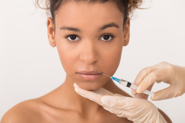 Lip augmentation. Woman getting lips injection in salon - 写真・画像