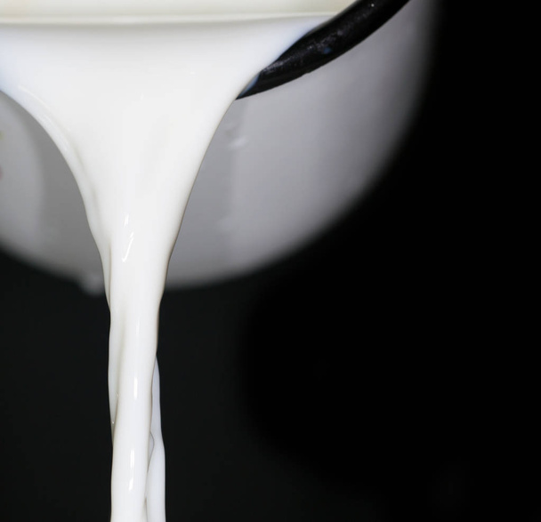 milk on a black background - Фото, изображение
