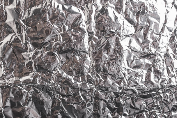 Silver crumpled foil shiny metal texture background wrapping paper for wallpaper decoration element. Grey platinum metallic - Photo, Image