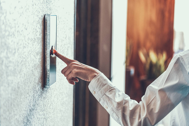 Woman pressing the elevator button with index finger - Foto, imagen