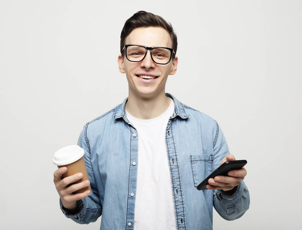  Portrait of happy man talking on phone and drinking coffee - Foto, Bild