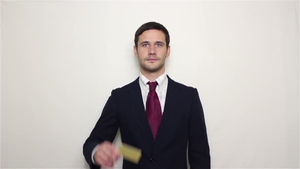 Young handsome businessman shows his golden credit card. - Materiaali, video