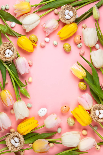 Beautiful white , pink and yellow tulips flowers and Easter eggs on pink  background. Spring flowers for Happy Easter card. Flat lay, top view. - Fotografie, Obrázek