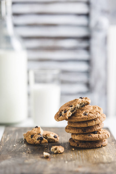oatmeal cookies with chocolate and milk on a light background - Foto, imagen