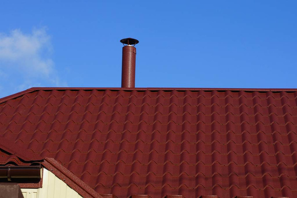 red tile roof and chimney against the blue sky - Photo, Image