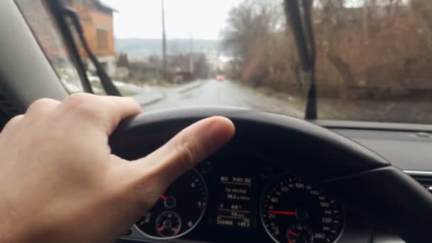Close-up arm that holds the wheel of a car. Dynamic movement of the car on a cloudy day. The camera shakes and repeats the cars motion in the pits - Footage, Video
