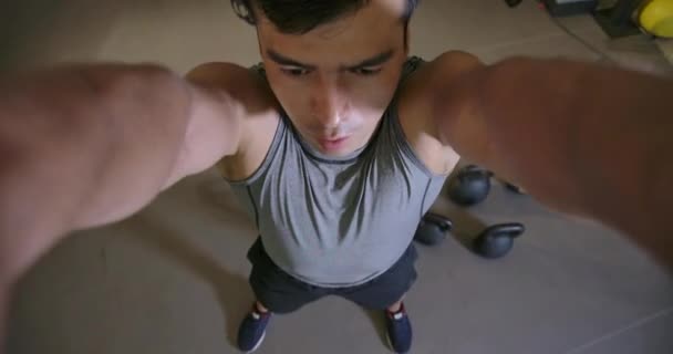 POV of Young caucasian man in crossfit gym doing exercise with kettlebell in slow motion. - Materiał filmowy, wideo