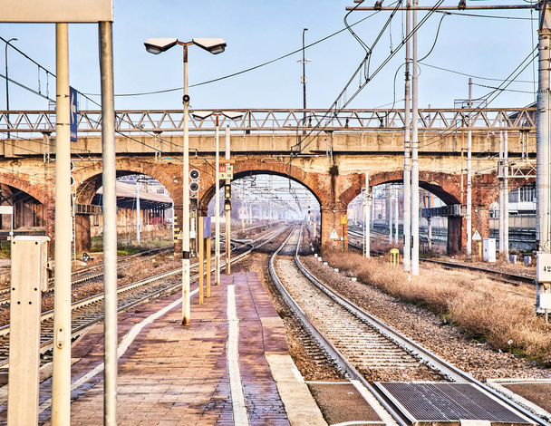 カテナリーによってヨーロッパの古いレンガ橋を渡る鉄道の鉄道駅. - 写真・画像
