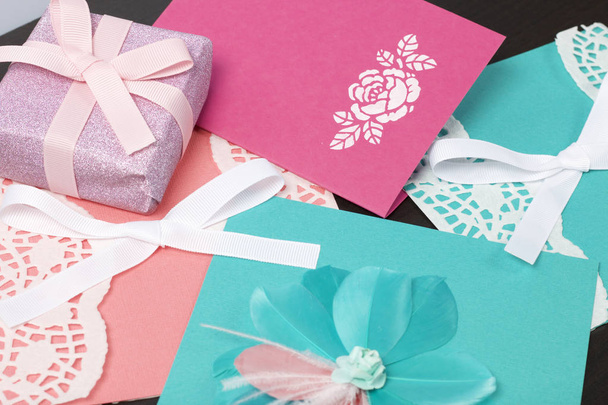 Handmade greeting cards. Near gift in wrapping paper, tied with a ribbon. Original gift. - 写真・画像