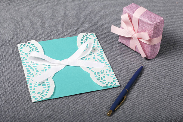 Handmade greeting card. Near gift in wrapping paper, tied with a ribbon. Original gift. - Fotó, kép
