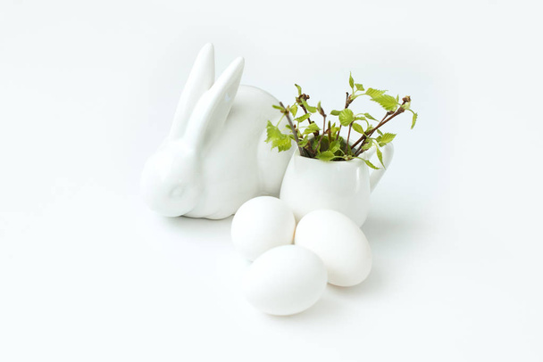 happy Easter eggs and branch white  background and white easter bunny - Foto, Imagem