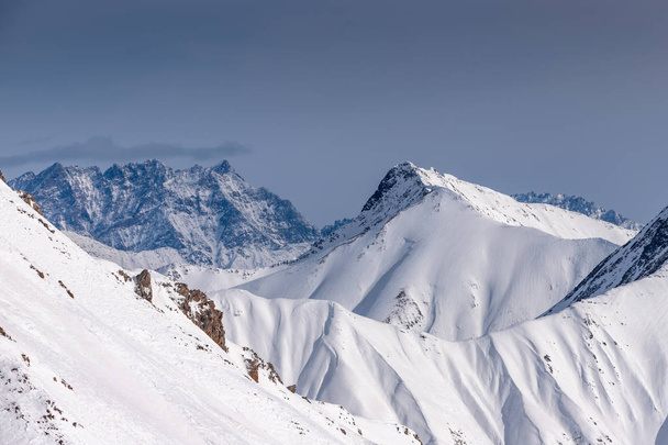 Snowy winter mountains in sun day. Caucasus Mountains, Georgia, from ski resort Gudauri - Photo, Image