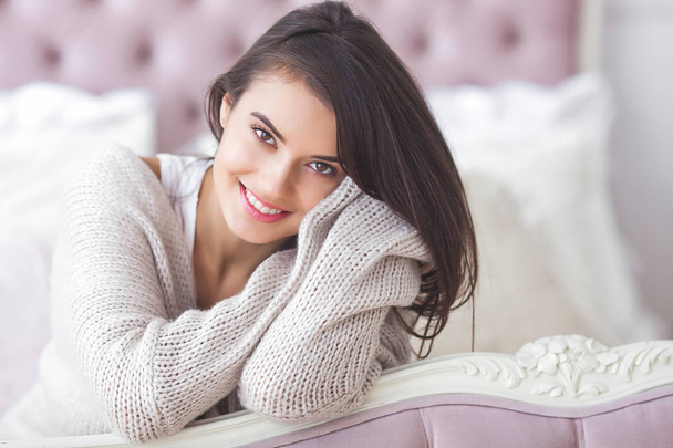 Young attractive woman indoors. Girl on neutral background. Happy woman. Female in the bedroom at home. Close up portrait of beautiful lady. - Valokuva, kuva