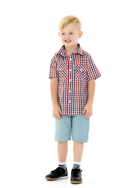 A cute little boy in a shirt and shorts. - Photo, image