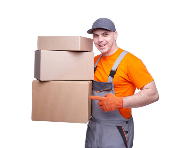 Loader in workwear, profession of the service industry, cardboard box, parcel delivery, young sports man, cargo transportation, courier in working clothes, worker isolated on white background - Photo, Image