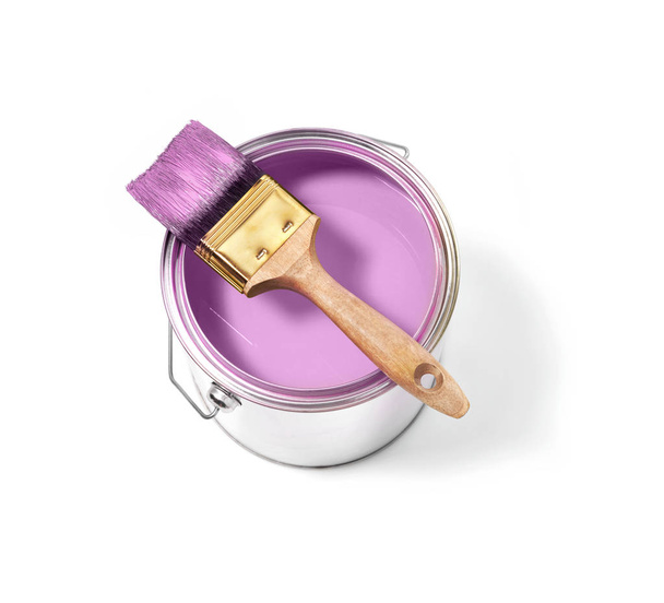 Pink paint tin can with brush on top on a white background with pink strokes - Foto, imagen