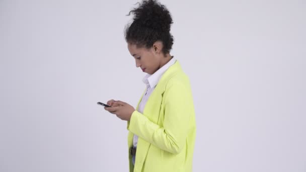 Profile view of young African businesswoman with phone being taken away - Video