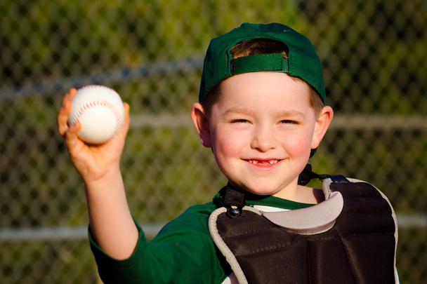 Young child in catcher s gear throwing baseball - Фото, зображення