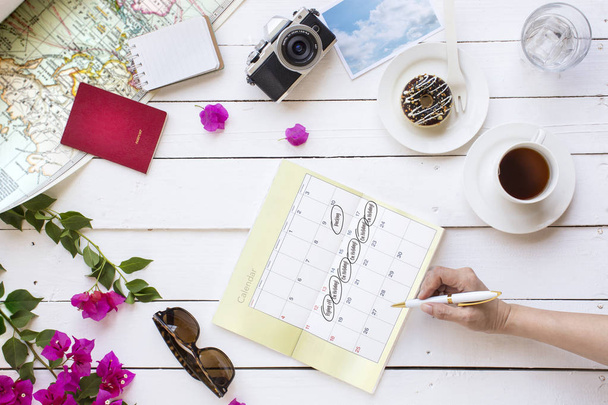 Summer travel vacation planning and objects on white outdoor cafe table top. - Photo, Image