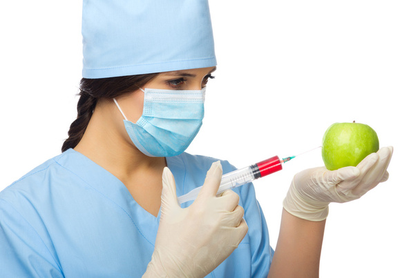 Chemist with syringe and apple - Foto, Imagem