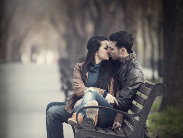 Couple kissing at the bench at alley. - Photo, Image