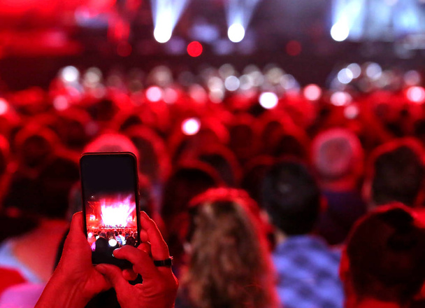 audience with modern smartphones while filming the live rock concert - Photo, Image