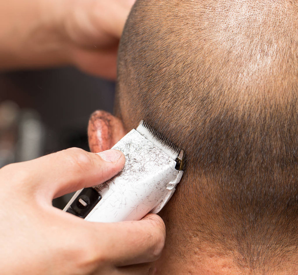 Close up of a male student having a haircut with hair clippers - Φωτογραφία, εικόνα